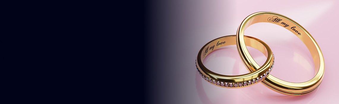 Anelli d'oro intrecciati con pietre scintillanti, testo inciso 'all my love' su sfondo sfumato rosa e nero.